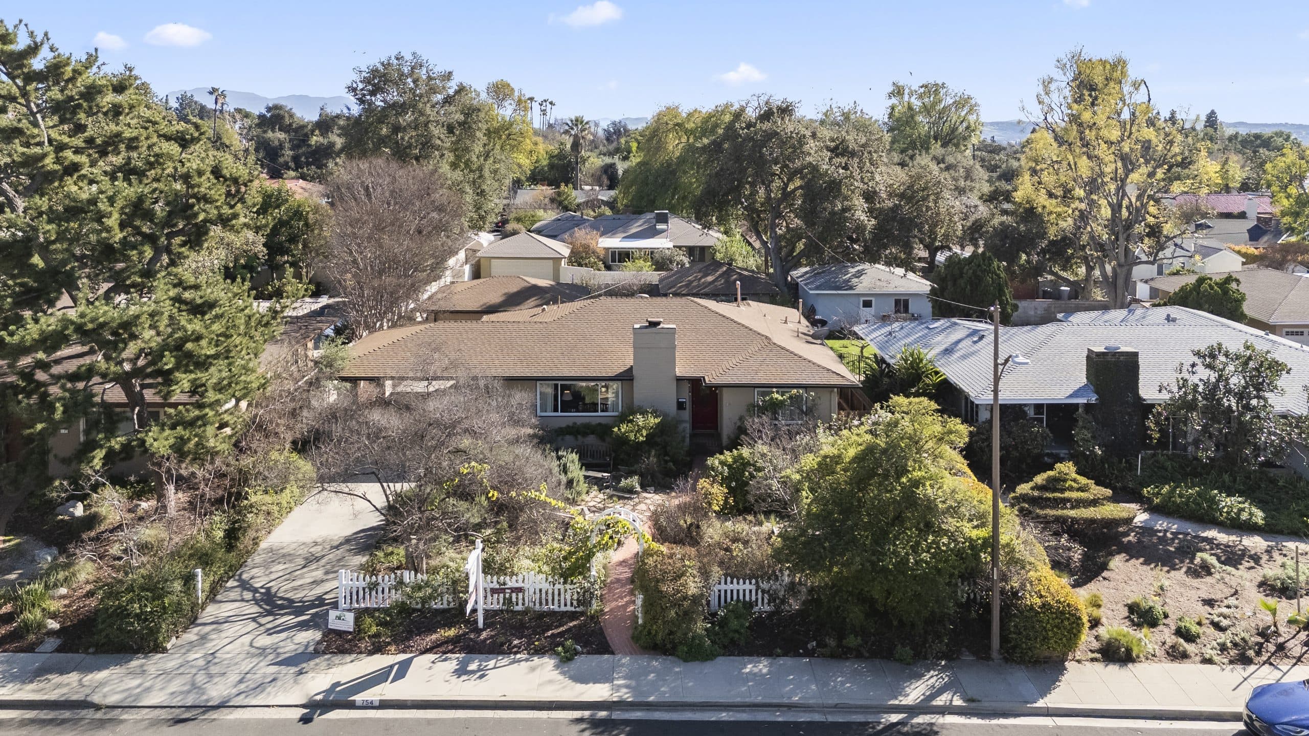 Aerial view of a tree-lined Claremont residential street with mid-century single-story homes