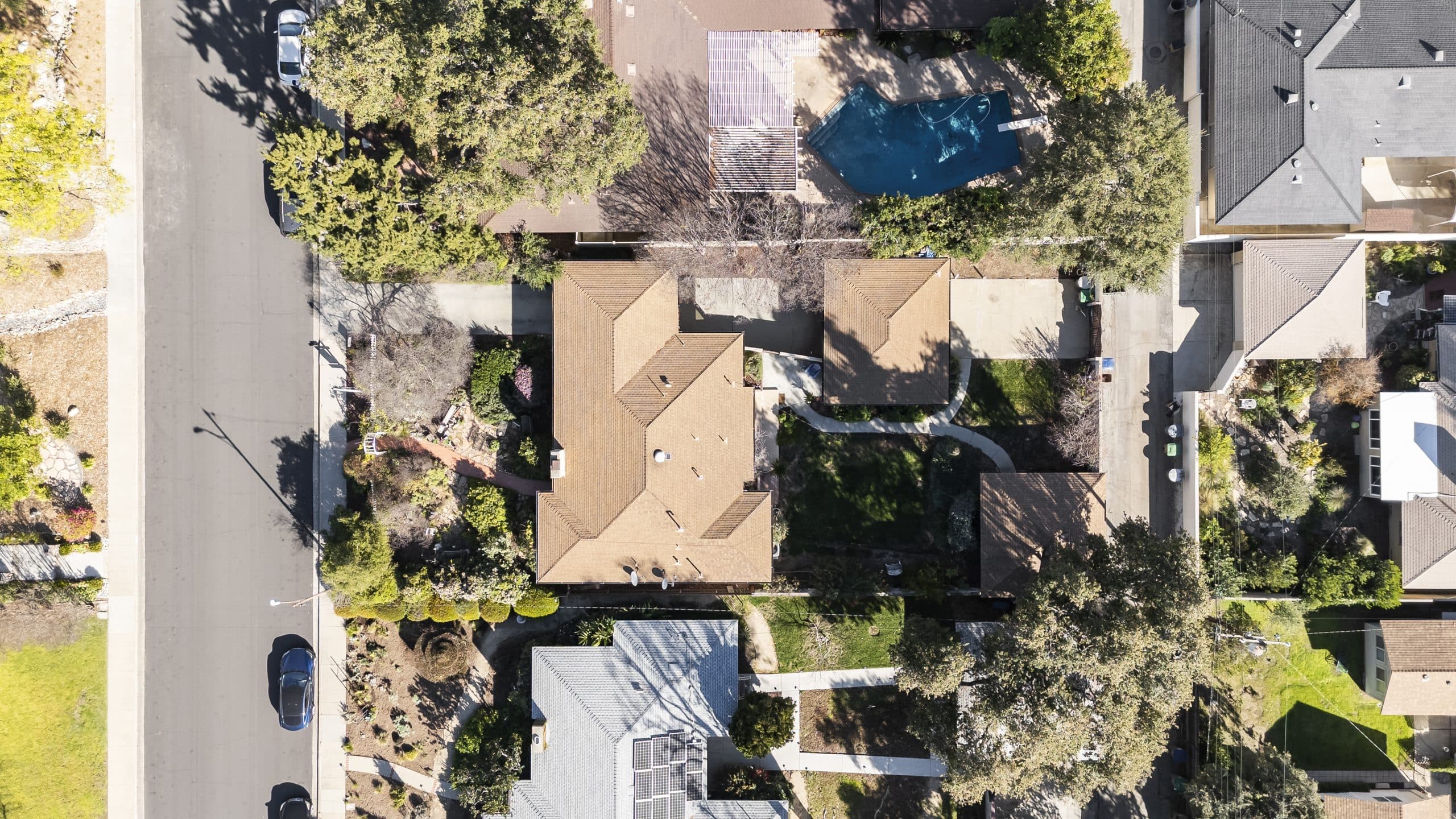 Aerial view of a tree-lined Claremont neighborhood block