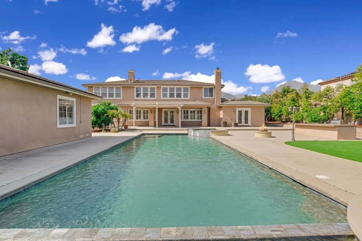 Long pool leading to the rear elevation of a Claremont home