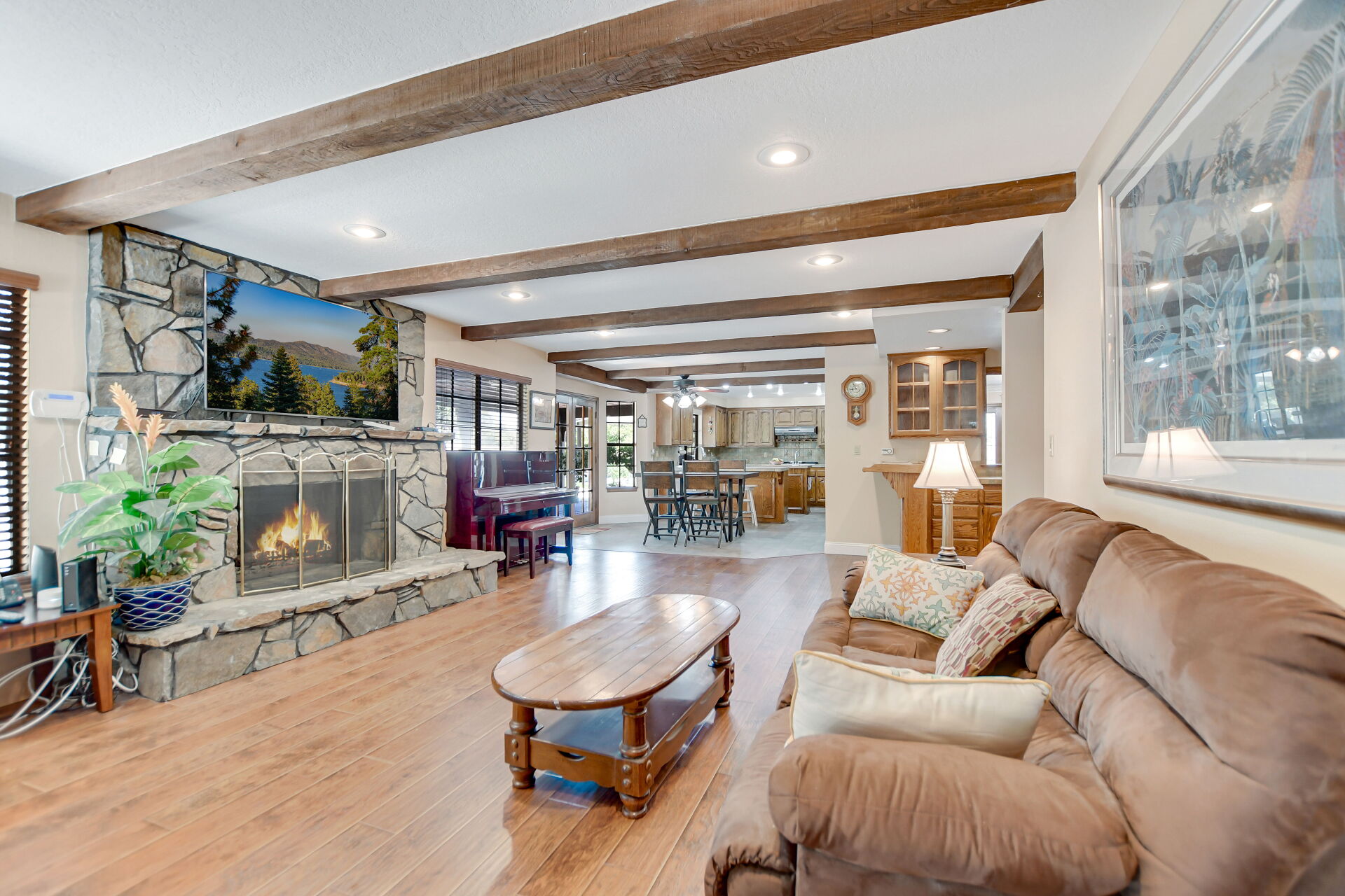 Family room with a floor-to-ceiling stone fireplace in a Claremont home