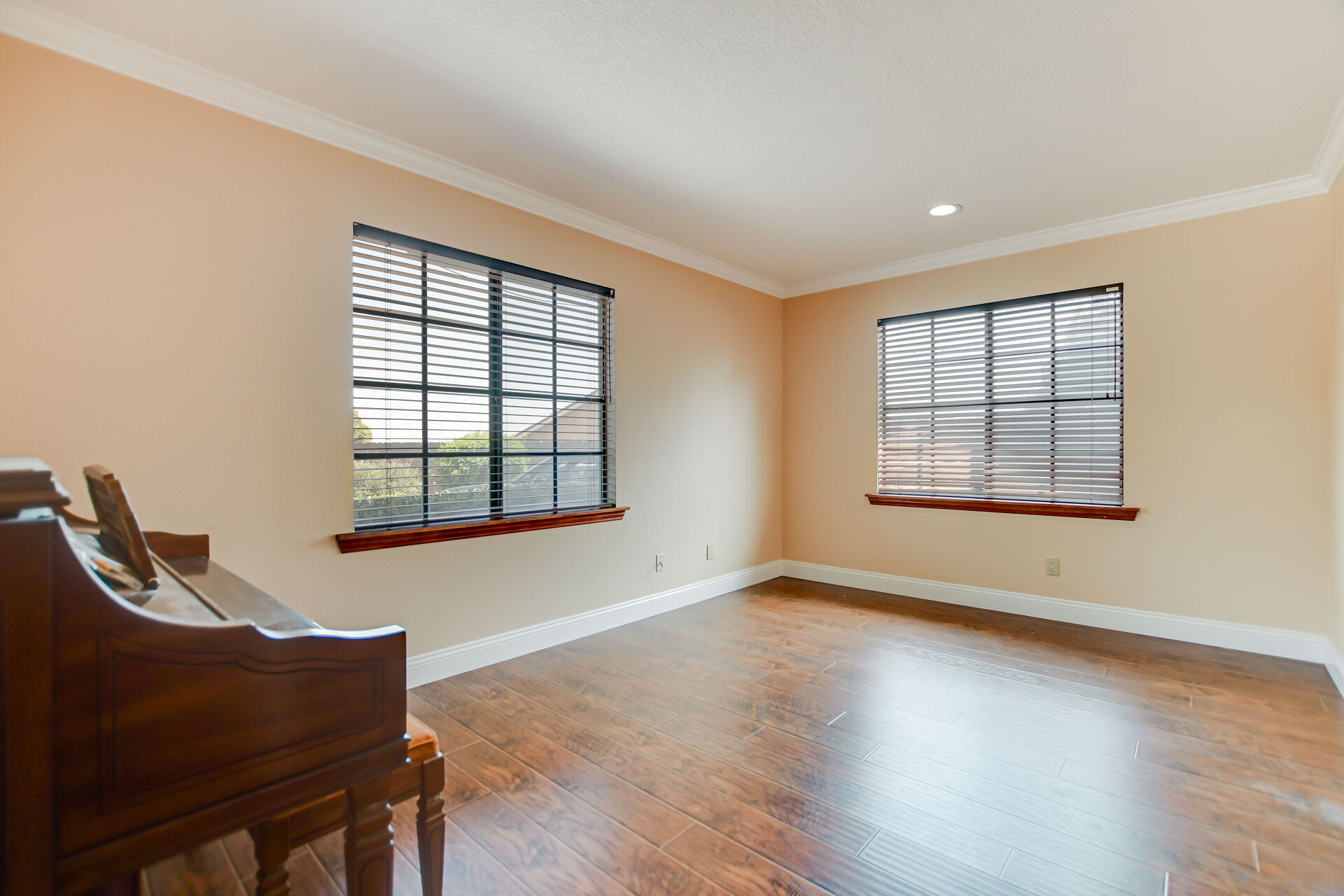 Claremont sitting room with an heirloom upright piano, the kind of furnishing an inherited estate passes down
